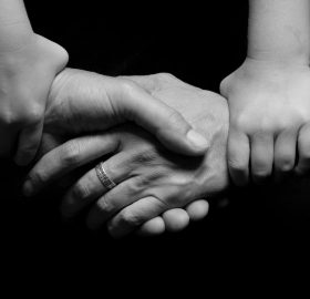 black and white connected hands love